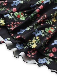 Detail of floral tiered skirt with strawberry print and layered ruffle hemline