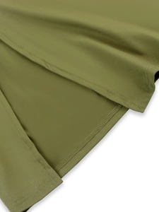 Detail view of olive green dress hem showing professional double-needle stitching and seams