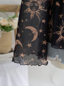 Detail of sheer black mesh top with vintage celestial sun and moon prints and ruffled edge