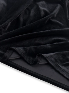 Detailed view of premium black velvet fabric showing soft texture and neat hemline stitching
