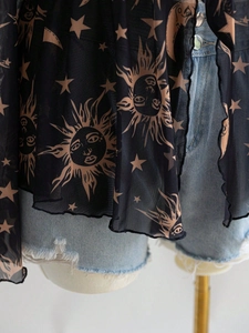 Detail of sheer mesh top with gold sun and moon prints and vintage wavy edge finish