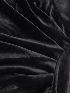 Close-up of premium black velvet fabric with luxurious folds and glossy texture details