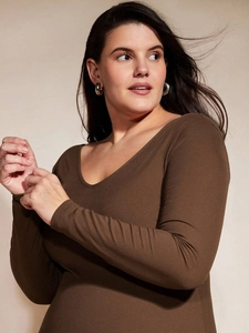 Close-up of dark coffee ribbed knit fabric and elegant V-neckline on a midi dress