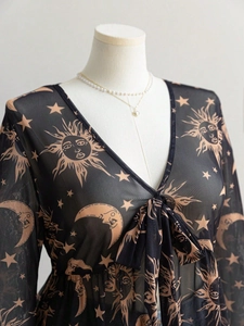Detail of V-neck mesh top with celestial sun and moon prints and elegant bow tie