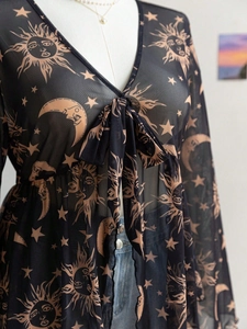 Detailed view of sheer mesh V-neck top featuring celestial sun and moon prints