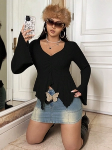 Women's V-neck long sleeve black top with flare sleeves and irregular hem detail