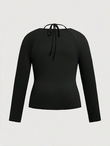 Women's slim fit black long sleeve top with halter neck tie and raglan sleeves