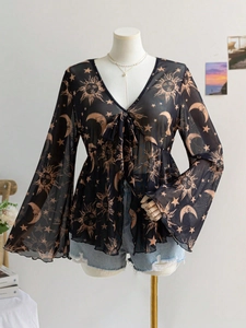 Detail of V-neck mesh top with celestial sun and moon prints and flared sleeves