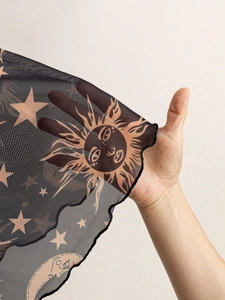 Close-up of sheer black mesh fabric with vintage gold sun and moon celestial prints