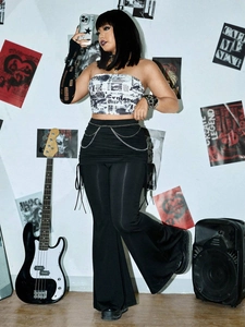 Punk style high waisted black wide leg trousers with chains and newspaper print tube top