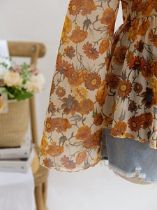 Detail of floral mesh top with bell sleeves and romantic vintage rose print fabric
