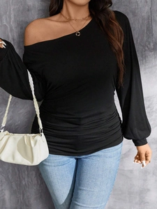 Women's black off-shoulder long sleeve top with ruching details and slim fit style