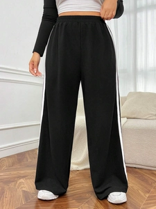 Women's plus size wide leg lounge pants in black with side white stripe and elastic waist