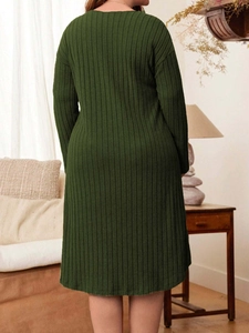 Deep green long sleeve ribbed knit dress in a relaxed fit for women, shown from the back view