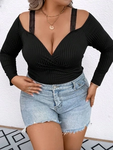 Slim fit black ribbed knit top with V-neck wrap design and lace shoulder straps