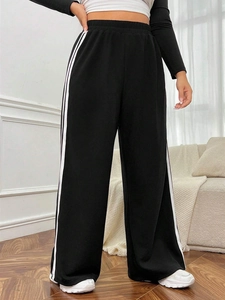 Minimalist high waisted black wide leg trousers with white stripes for women casual look