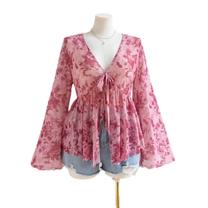 Pink floral mesh V-neck top with flare sleeves and front tie closure in a loose airy style