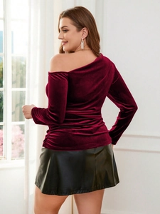 Elegant off-shoulder burgundy velvet long sleeve top paired with a black leather mini skirt