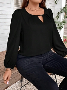 Detail of black plus size top with V-neck cutout, pleated collar, and lantern sleeves