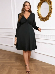 Elegant plus size black V-neck long sleeve dress with twist knot detail and A-line silhouette
