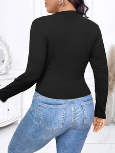 Slim fit black ribbed long sleeve top with crew neck paired with denim jeans