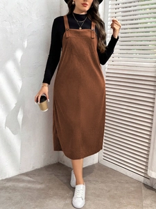 Women's brown corduroy pinafore midi dress with black turtleneck top in minimalist style