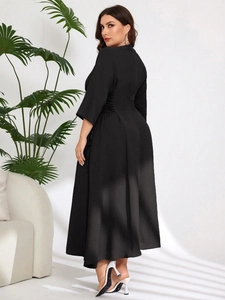 Detailed side view of black plus size midi dress featuring elegant ruching at the waist
