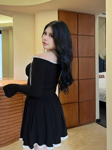 Off-shoulder black long sleeve mini dress with white lace trim and bow accents