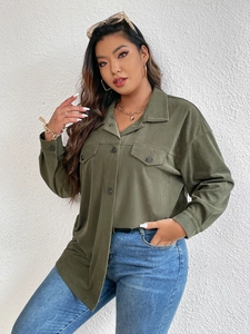 Close-up of dark green corduroy shirt featuring chest pockets and vertical texture