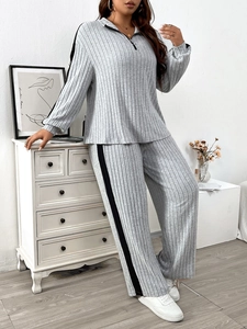 Women's casual grey knit two-piece set with half-zip top and wide-leg striped pants