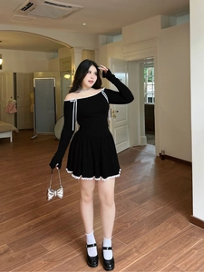 Women's black off-shoulder long sleeve mini dress with white lace trim and ribbon bows