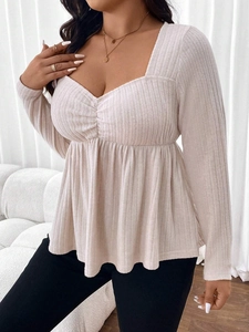 Close-up of ribbed long sleeve top featuring sweetheart neckline and ruched bodice detail