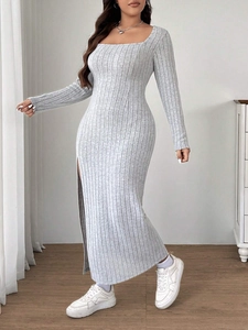 Detail view of the side slit and ribbed knit fabric texture of the grey maxi dress