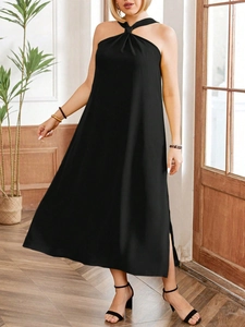Elegant black halter neck dress with high slit detail and flowing draped fabric