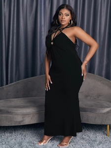 Detail of cross halter neckline with metal ring buckle on slim black bodycon dress