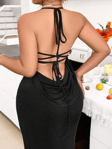 Elegant black backless knit maxi dress with halter neck and cross-strap detail
