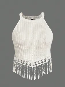 Detail of white cable knit halter top featuring elegant long tassel fringe hem decoration