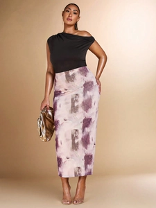 Women's black off-shoulder T-shirt with abstract print maxi skirt and golden clutch