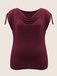 Detail of elegant wine red sleeveless top featuring a draped cowl neck and shoulder ties