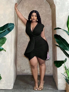 Plus size black V-neck bodycon dress with ruched knot detail and asymmetrical hemline