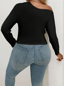 Women's black off-shoulder long sleeve top paired with slim-fit light blue denim jeans