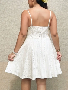 White eyelet embroidery mini dress with adjustable straps and slim fit A-line silhouette