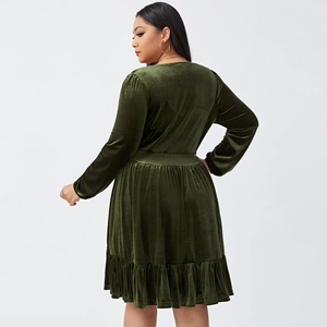 Rear view of dark green velvet party dress showing high waist cut and ruffled hemline