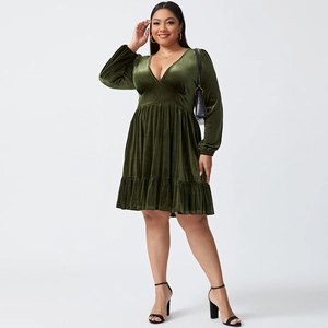 Close-up of deep green velvet texture and ruffled hem of the V-neck party dress