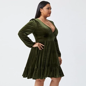 Detail of dark green velvet party dress with elegant V-neck and ruffled skirt hem