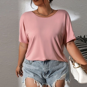 Pink crew neck short sleeve knit top for plus size women paired with denim shorts