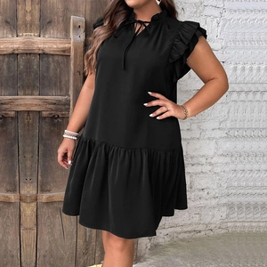 Detail of ruffle hem and tie neckline on a black sleeveless plus size summer dress