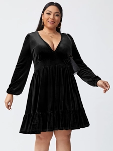 Close-up of deep V-neck and high waist details on black velvet plus size party dress