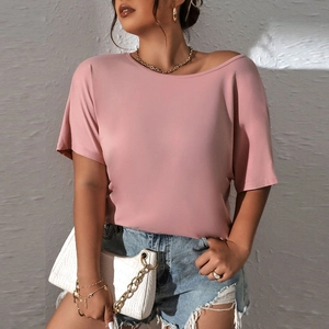 Close-up of a loose fit pink crew neck knitted T-shirt with soft fabric texture and drape