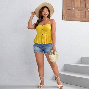 Detail of yellow camisole top with three dark buttons and ruffled hemline
